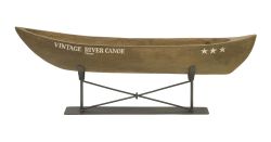 Vintage river canoe on metal stand